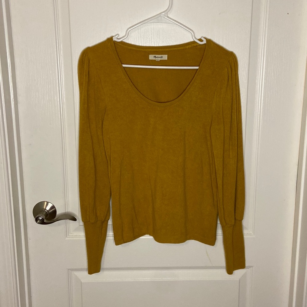Mustard yellow sweater with puffed sleeved shoulders.